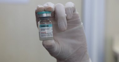 A healthcare worker holds a vial of the Turkish-developed COVID-19 vaccine Turkovac, at a hospital in Izmir, Turkey, Dec. 31, 2021. (AA Photo)