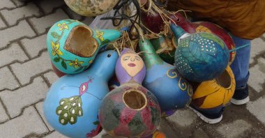 The Karakuş couple make birds nests from gourds and hang them on trees to help birds in the winter, in Afyonkarahisar, Turkey, Jan. 3, 2022. (AA Photo)