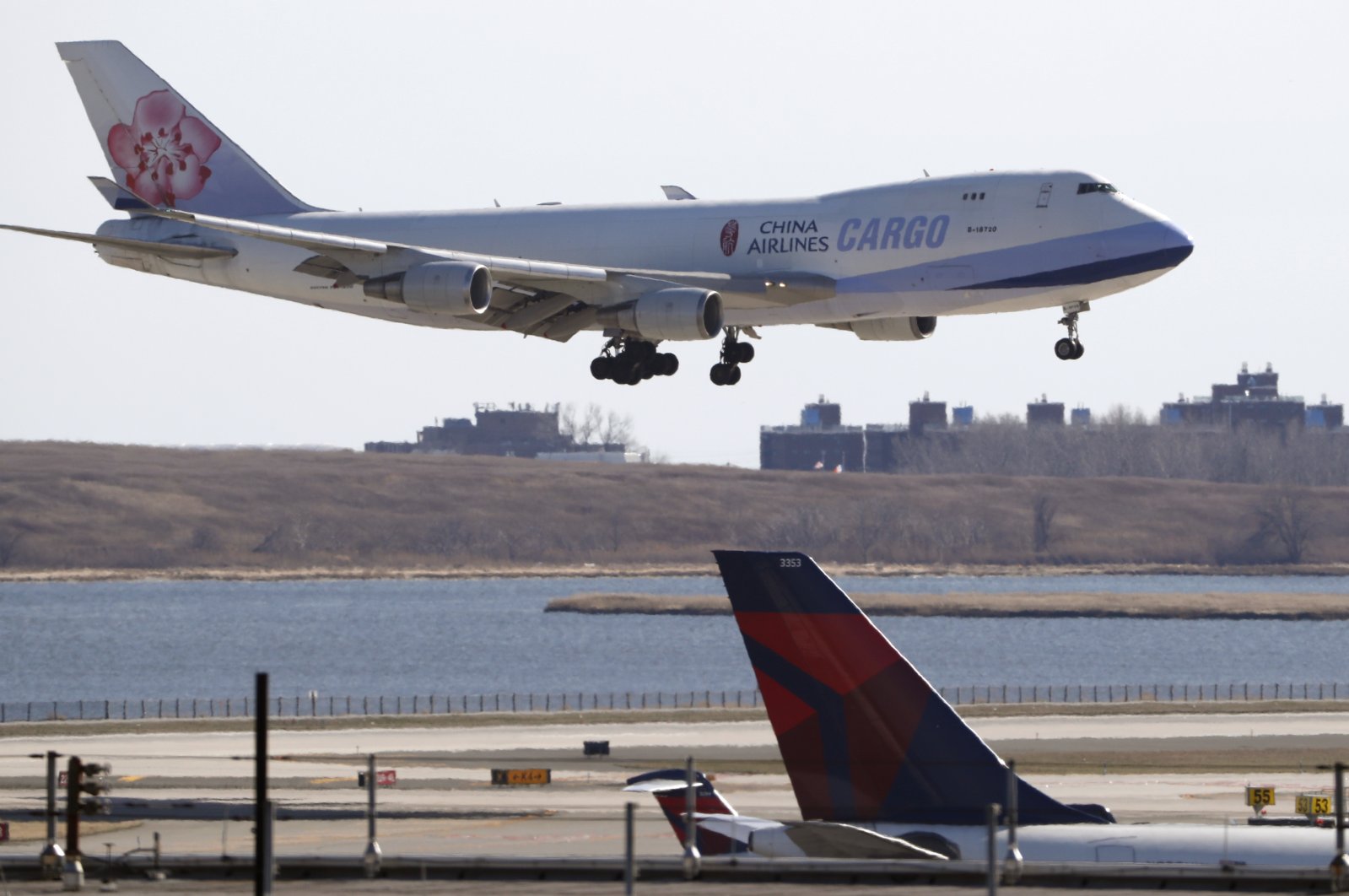 A China Airlines cargo jet lands at John F. Kennedy International Airport, New York, U.S., March 14, 2020. (AP Photo)