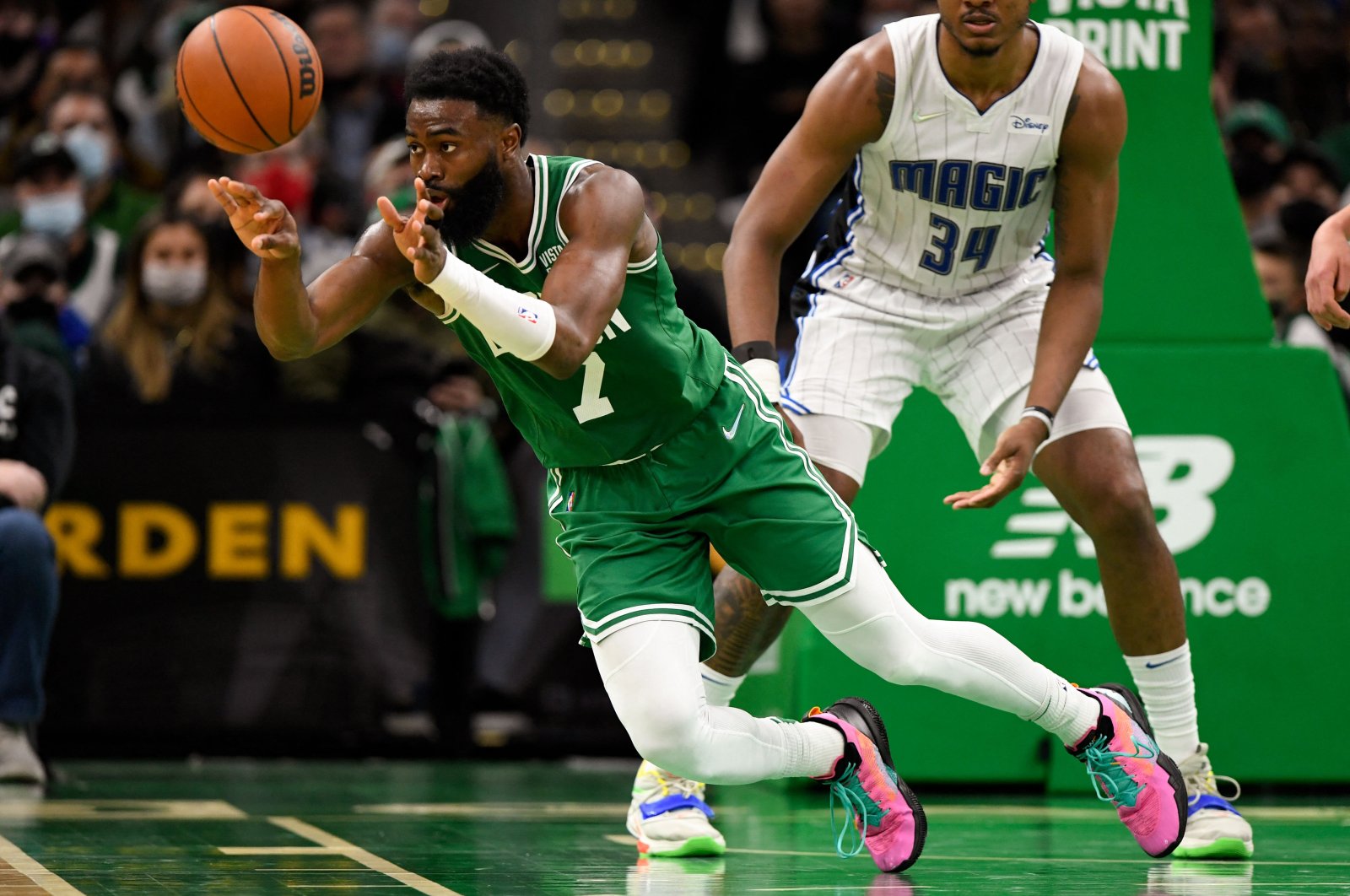 Boston Celtics guard Jaylen Brown (L) passes the ball during an NBA game against the Orlando Magic, Massachusetts, U.S., Jan 2, 2022. (Reuters Photo)