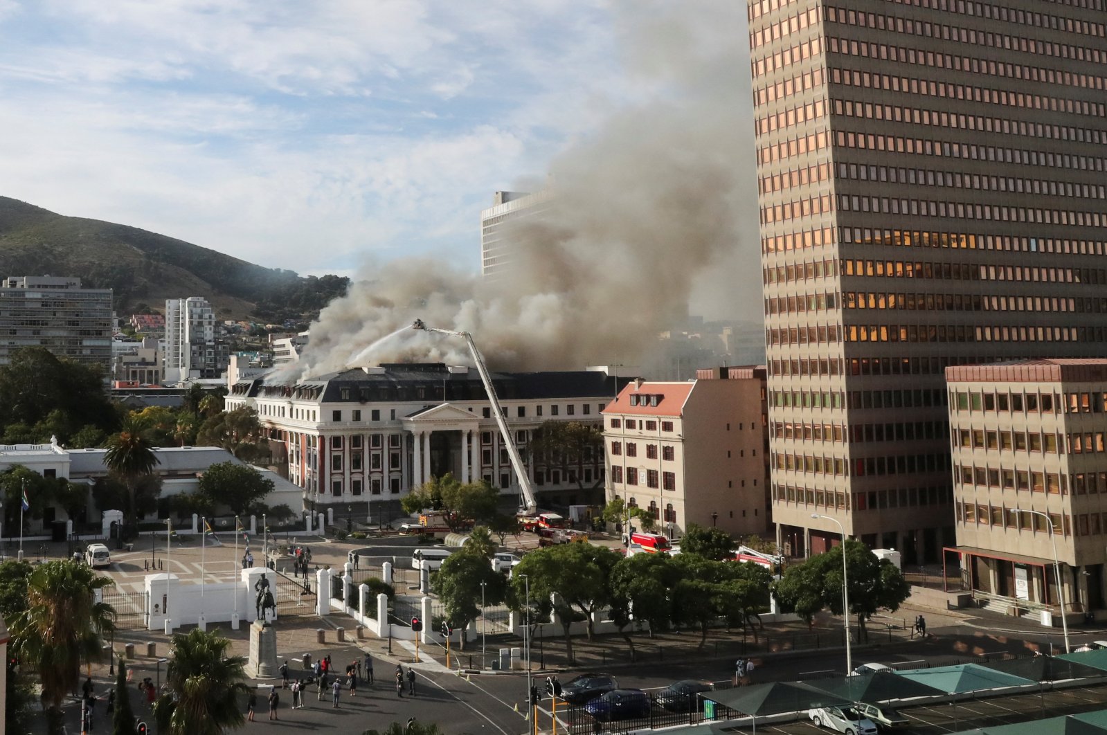 Firefighters work at the parliament as the fire flared up again, in Cape Town, South Africa, Jan. 3, 2022. (REUTERS/Sumaya Hisham)