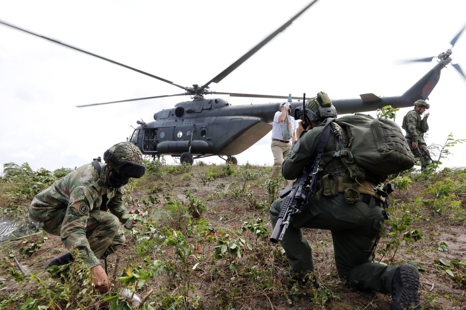 Members of the Colombian Police and Army arrive at a field to eradicate illicit crops in the rural area of San Pablo, south of the Bolivar department, Colombia, Dec. 30, 2021. (EPA/Carlos Ortega)