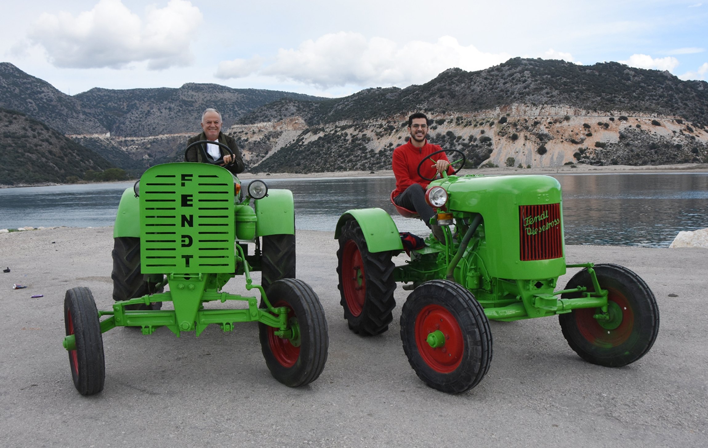 Mehmet Bayraktaroğlu dan putranya Hüseyin duduk di atas traktor merek Fendt Dieselross yang telah dipugar dan beroperasi sepenuhnya dari tahun 1952 dan 1950, Antalya, Turki selatan, 20 Desember 2021. (Foto DHA)