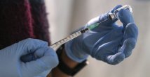 A staff member from the National Health Organization (EODY) prepares a booster Johnson and Johnson COVID-19 vaccine shot at Karatepe refugee camp on the Aegean island of Lesbos, Greece, Dec. 15, 2021. (AP Photo)