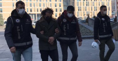 Police escort a captured FETÖ suspect, in Kayseri, central Turkey, Jan. 3, 2022. (DHA PHOTO) 