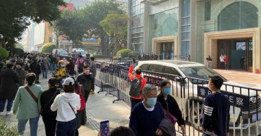 Protesters seeking payment from the China Evergrande Group gather as police officers stand guard outside the Evergrande International Center in Guangzhou, Guangdong province, China, Jan. 4, 2022. (Reuters Photo)