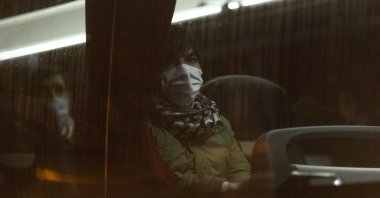 A refugee from Afghanistan is evacuated by bus to a shelter after camping for months beneath a motorway, in Paris, France, Dec. 17, 2021. (Photo by Getty Images)