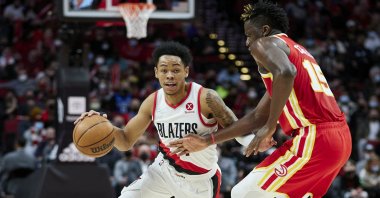 Portland Trail Blazers guard Anfernee Simons (L) dribbles around Atlanta Hawks center Clint Capela during an NBA game in Portland, U.S., Jan. 3, 2022. (AP Photo)