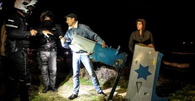 Police speak with Israelis as they hold parts of a military helicopter at the shore after it crashed off the coast of the Mediterranean near Haifa, Israel, Jan. 3, 2022. (Reuters Photo)
