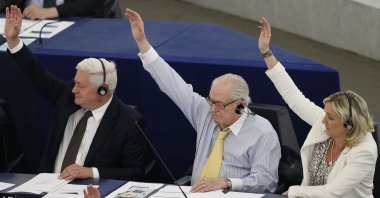 Marine Le Pen (R), France's far-right National Front political party leader, her father Jean-Marie (C) and far-right National Front political party member Bruno Gollnisch vote against the waiver of the parliamentary immunity of Marine Le Pen during a voting session at the European Parliament, Strasbourg, France, July 2, 2013. (Reuters Photo)