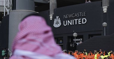A man with a Saudi Arabian headdress passes by the St. James' Park in Newcastle, England, Oct. 17, 2021. (AP Photo)