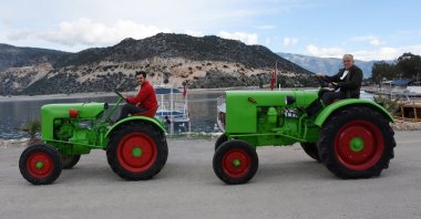Mehmet Bayraktaroğlu and his son Hüseyin sitting on two fully restored and operational Fendt Dieselross brand tractors originally produced over 70 years ago, Antalya, southern Turkey, Dec. 20, 2021. (DHA Photo)