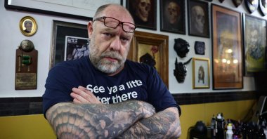 Tattoo artist Tin-Tin, head of the French National Union of Tattoo Artists, poses in his tattoo studio as new EU restrictions on colored tattoos come into force in Paris, France, Jan. 4, 2022. (Reuters Photo)