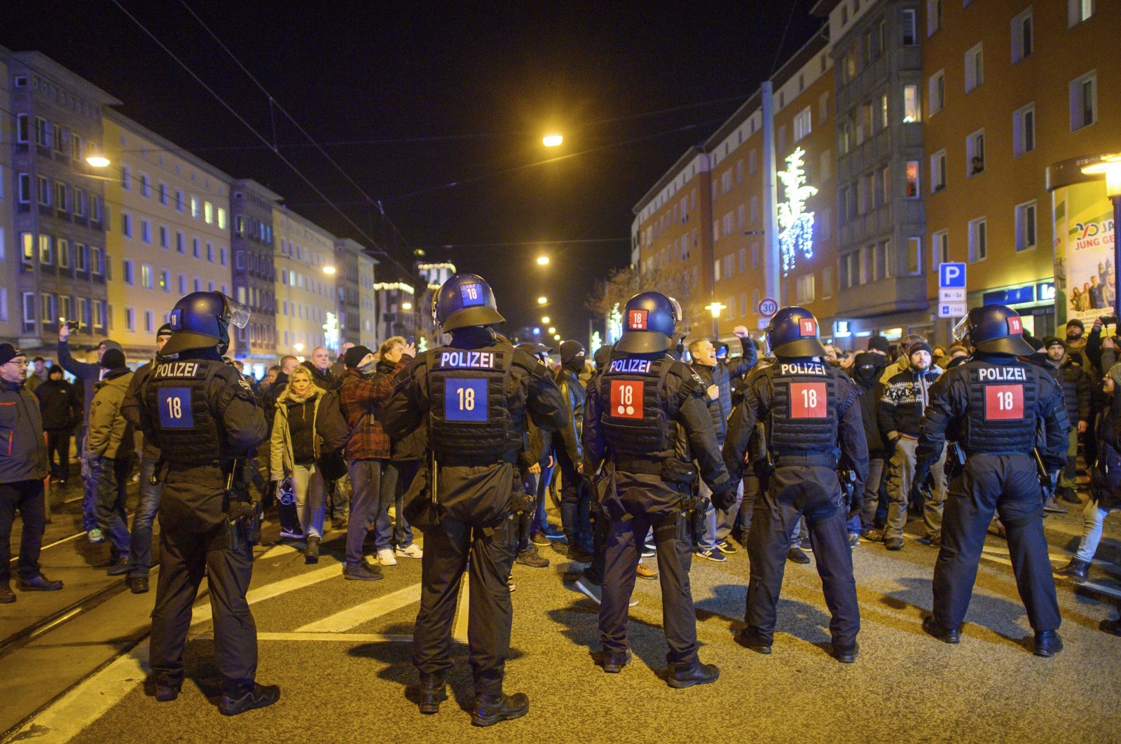 Police officers and protestors face each other in the city center of Magdeburg, Germany, Jan. 3, 2022. (AP Photo)