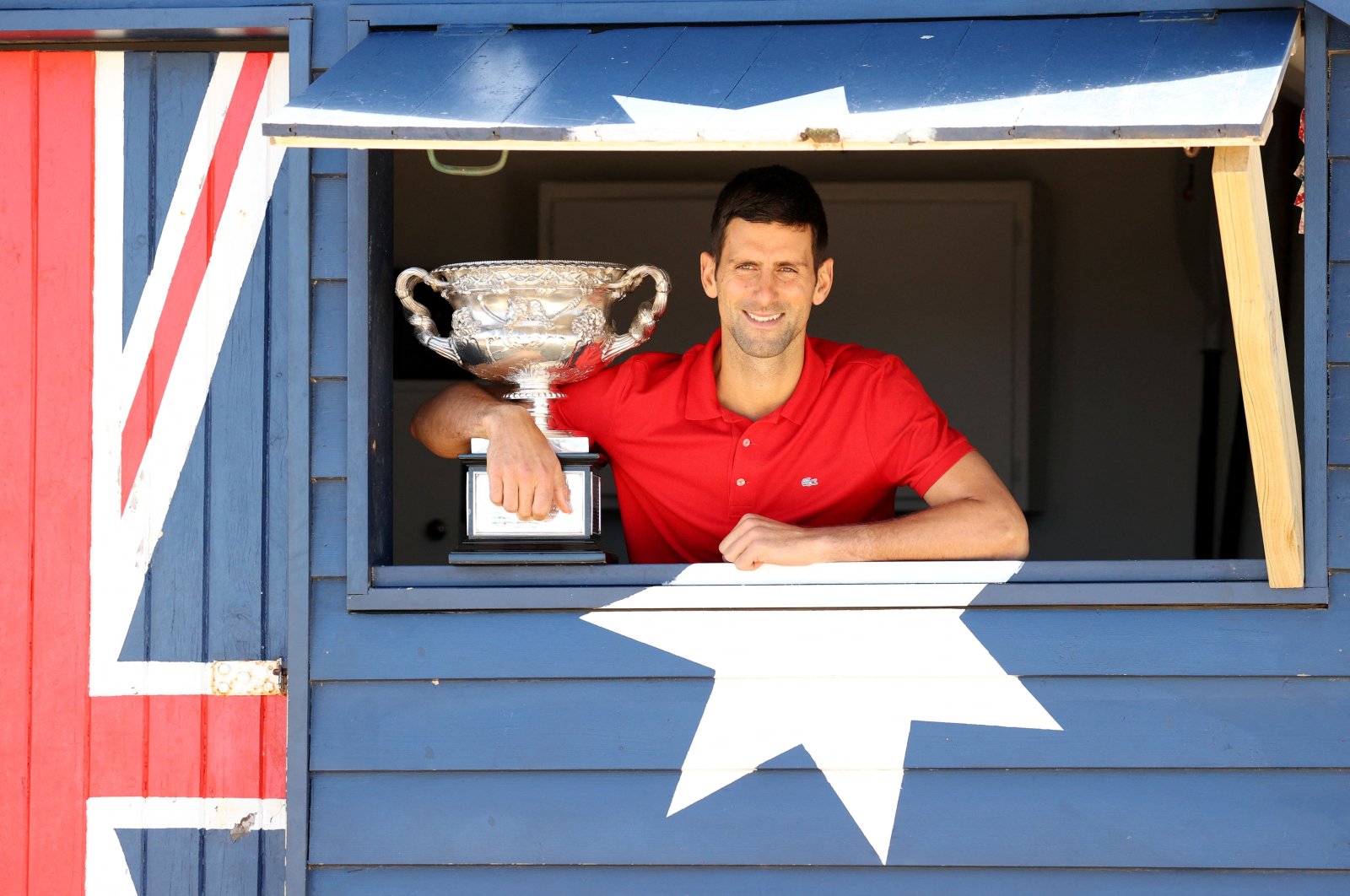 Serbia&#039;s Novak Djokovic poses with the Australian Open trophy, Melbourne, Australia, Feb. 22, 2021. (Reuters Photo)