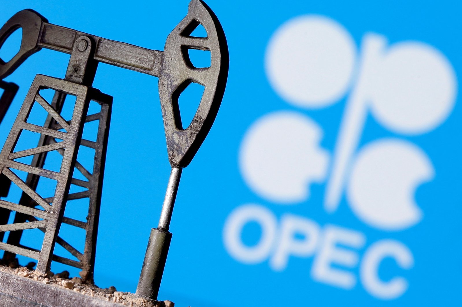 A 3D printed oil pump jack is seen in front of the OPEC logo in this illustration, April 14, 2020. (Reuters Photo)