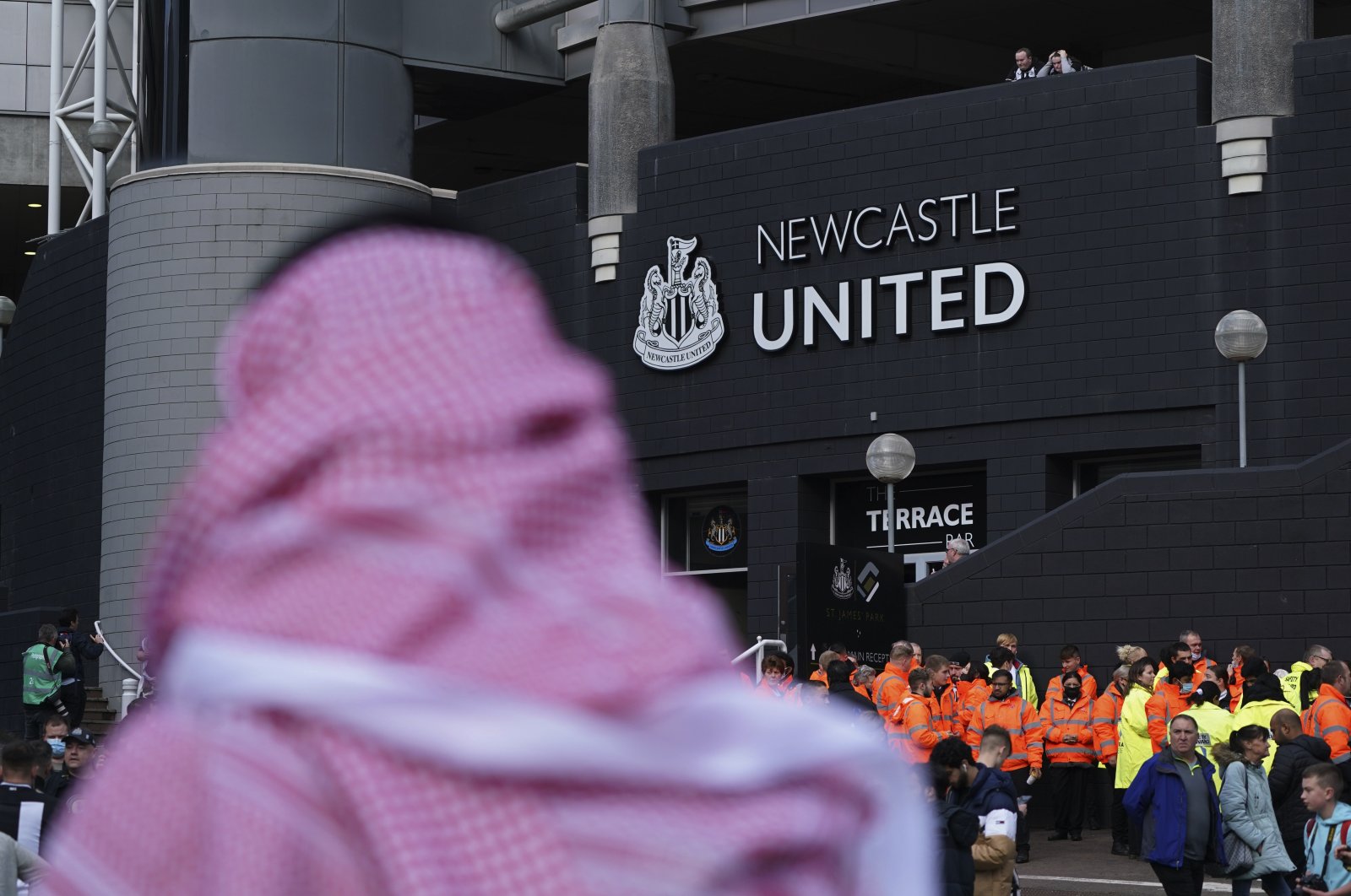 A man with a Saudi Arabian headdress passes by the St. James&#039; Park in Newcastle, England, Oct. 17, 2021. (AP Photo)