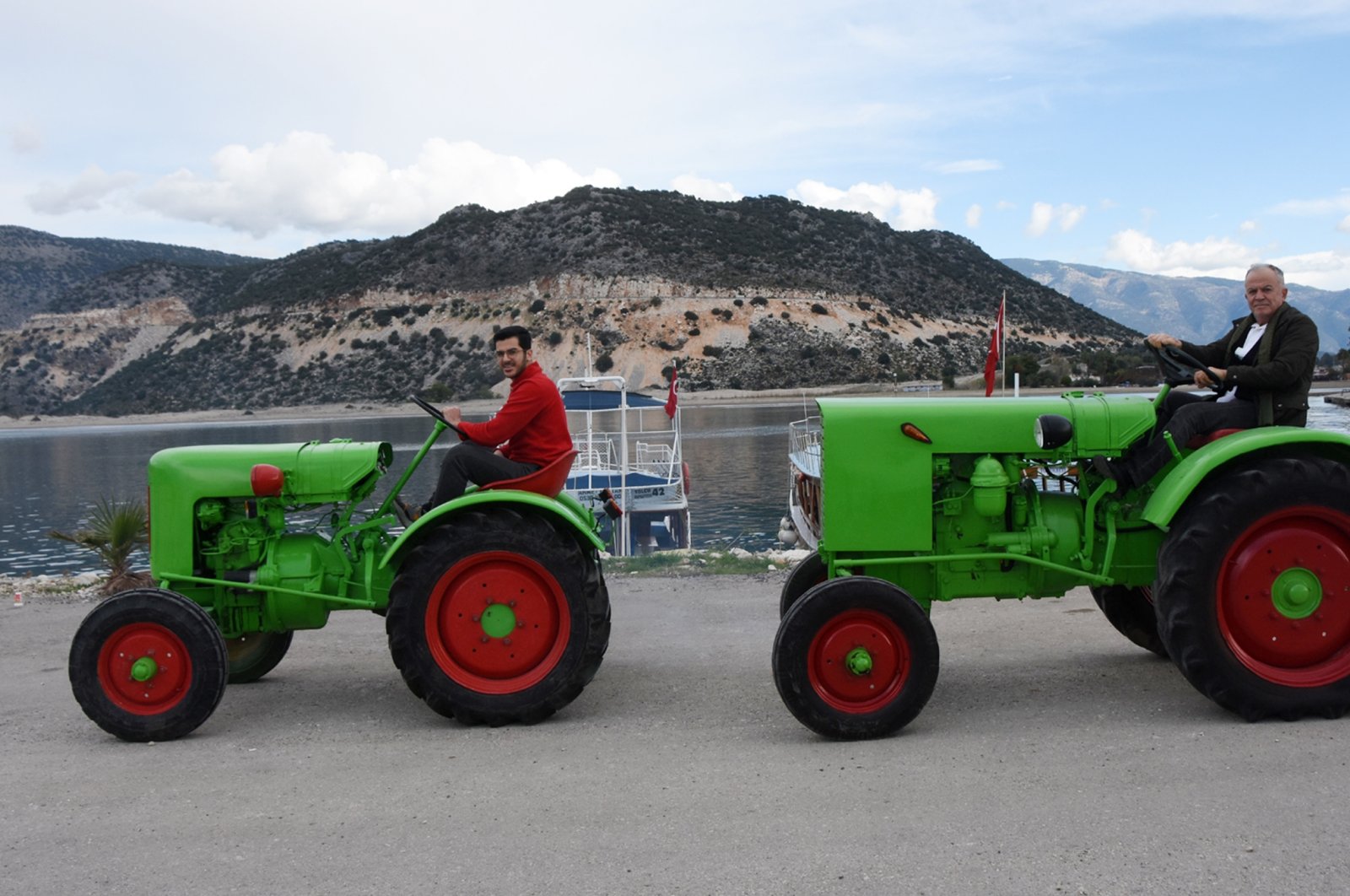 Mehmet Bayraktaroğlu and his son Hüseyin sitting on two fully restored and operational Fendt Dieselross brand tractors originally produced over 70 years ago, Antalya, southern Turkey, Dec. 20, 2021. (DHA Photo)