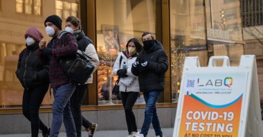 People walk past a COVID-19 testing station, New York, U.S., Jan. 4, 2022. (AFP Photo)