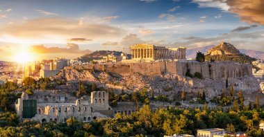 A view from the Acropolis of Athens in Greece with the Parthenon temple on top of the hill during a summer sunset. (Shutterstock)