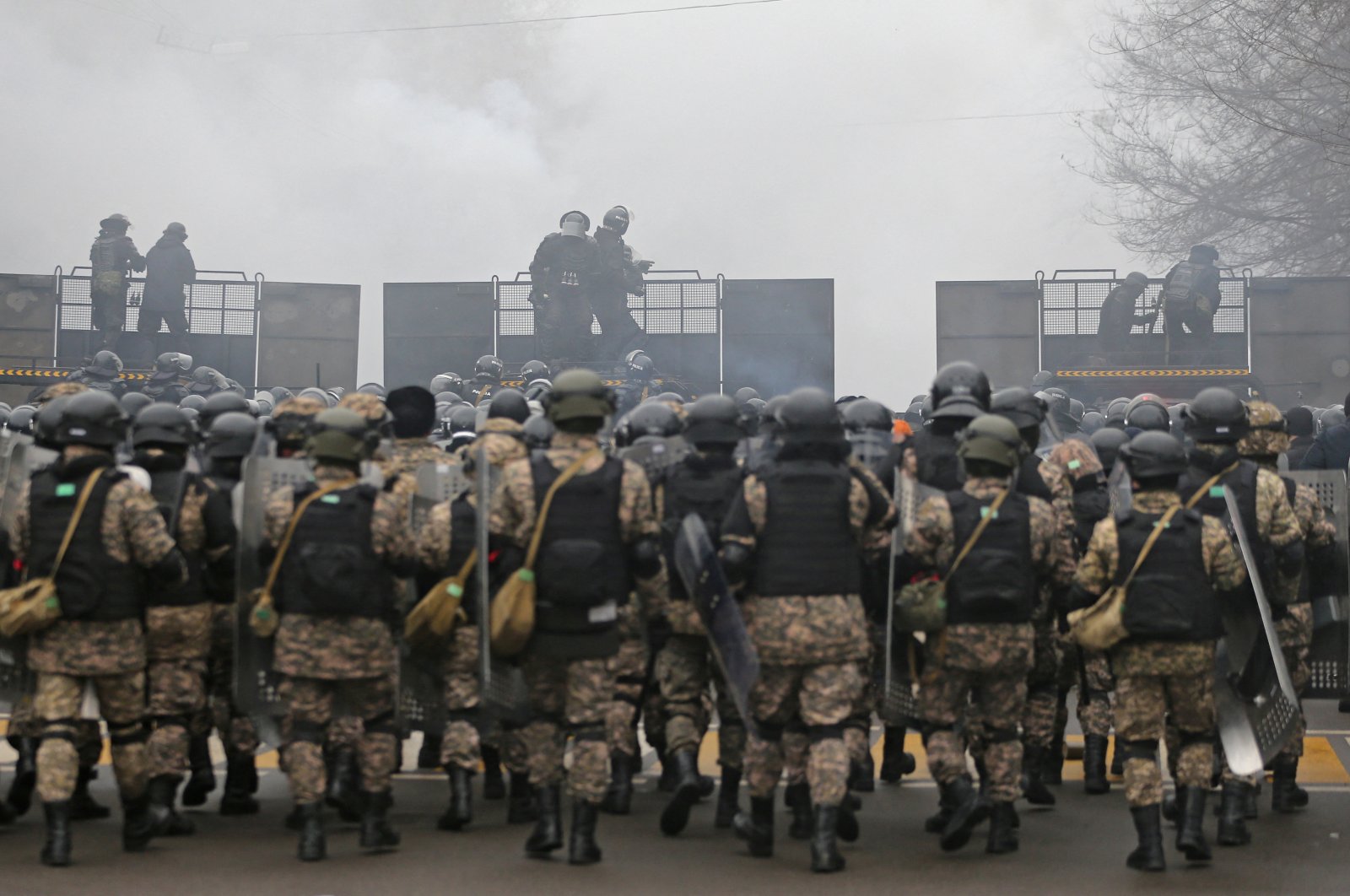 Kazakh law enforcement officers are seen on a barricade during a protest triggered by a fuel price increase in Almaty, Kazakhstan, Jan. 5, 2022. (Reuters Photo)