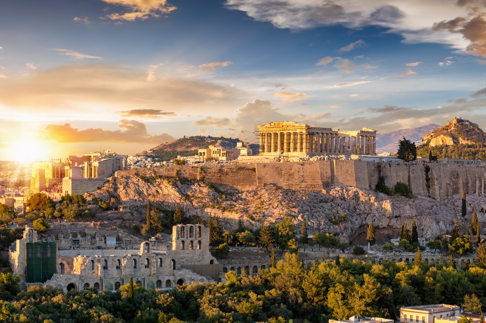 A view from the Acropolis of Athens in Greece with the Parthenon temple on top of the hill during a summer sunset. (Shutterstock)