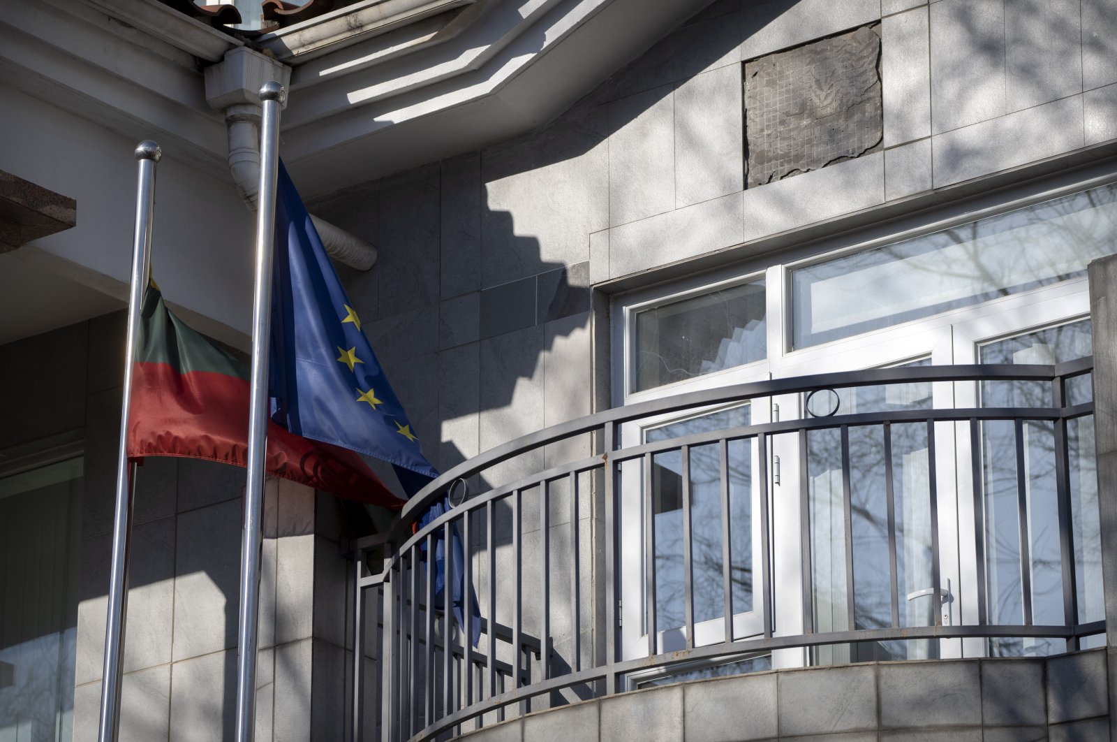Lithuanian and European Union flags fly outside the Lithuanian Embassy in Beijing, China, Dec. 16, 2021. (AP Photo)