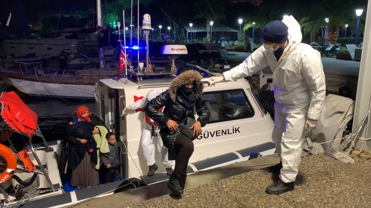 Coast guard officer assists irregular migrants saved during the rescue operation off Turkey&#039;s Izmir province, Wednesday, Jan. 5, 2022. (IHA Photo)