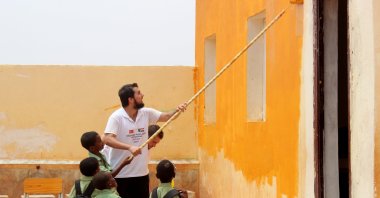 A TIKA volunteer paints the walls of a renovated school in Omdurman, Sudan, Aug. 17, 2017. (AA File Photo)