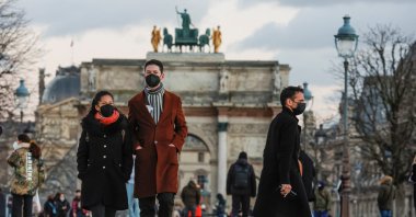 People wearing protective face masks walk in the Tuileries Gardens  amid the coronavirus outbreak in Paris, France, Jan. 5, 2022. (Reuters Photo)