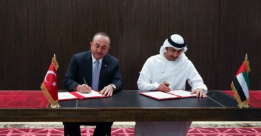 Foreign Minister Mevlüt Çavuşoğlu (L) and his UAE counterpart Sheikh Abdullah bin Zayed Al Nahyan sign a memorandum of understanding in Abu Dhabi, UAE, Dec. 15, 2021. (AFP Photo)