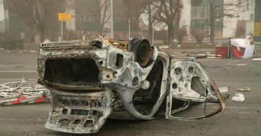 A burned-out automobile is seen on a square near an administrative quarter in central Almaty, Kazakhstan, Jan. 6, 2022. (AFP Photo)
