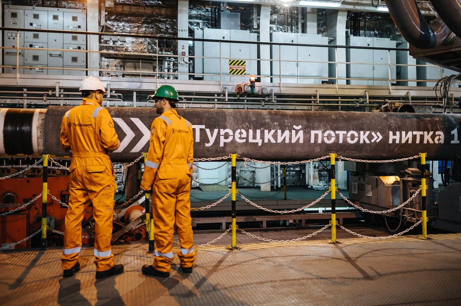 Workers stand in front of pipes to be laid on the Black Sea seabed by the vessel Pioneering Spirit as part of the TurkStream gas pipeline project, Feb. 5, 2018. (AA Photo)