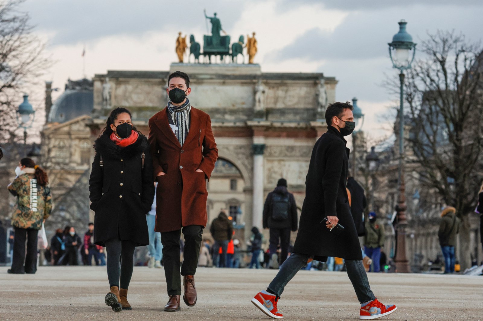 People wearing protective face masks walk in the Tuileries Gardens  amid the coronavirus outbreak in Paris, France, Jan. 5, 2022. (Reuters Photo)