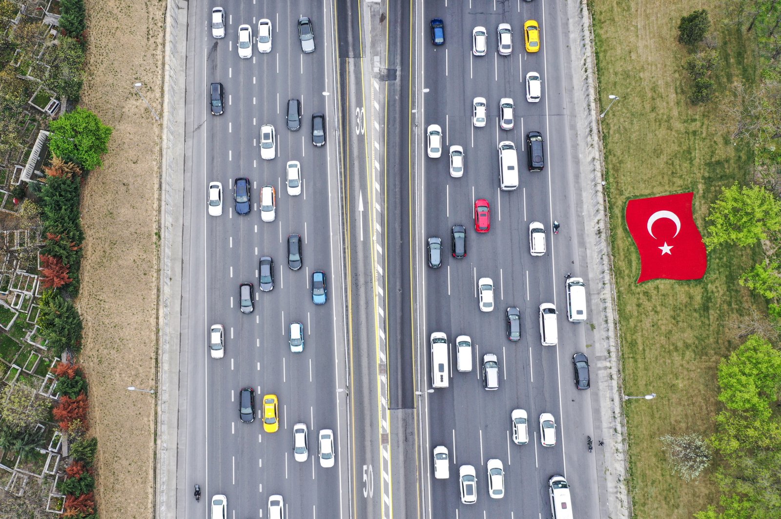 Cars drive on a highway near Haliç Bridge in Istanbul, Turkey, April, 28, 2021. (AA Photo)