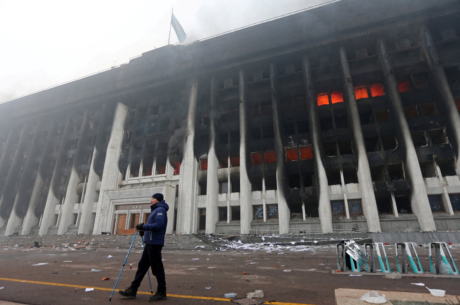 A man stands in front of the mayor&#039;s office building, which was torched during the protests triggered by an increase in fuel prices, in Almaty, Kazakhstan, Jan. 6, 2022. (Reuters Photo)