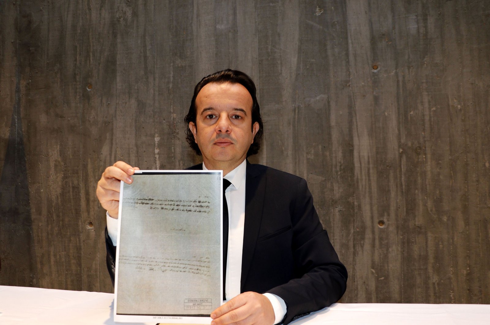 Troy Museum Director Rıdvan Gölcük holds a copy of an Ottoman-era document regarding the foundation of the museum, in Çanakkale, Turkey, Jan. 5, 2022. (AA Photo)