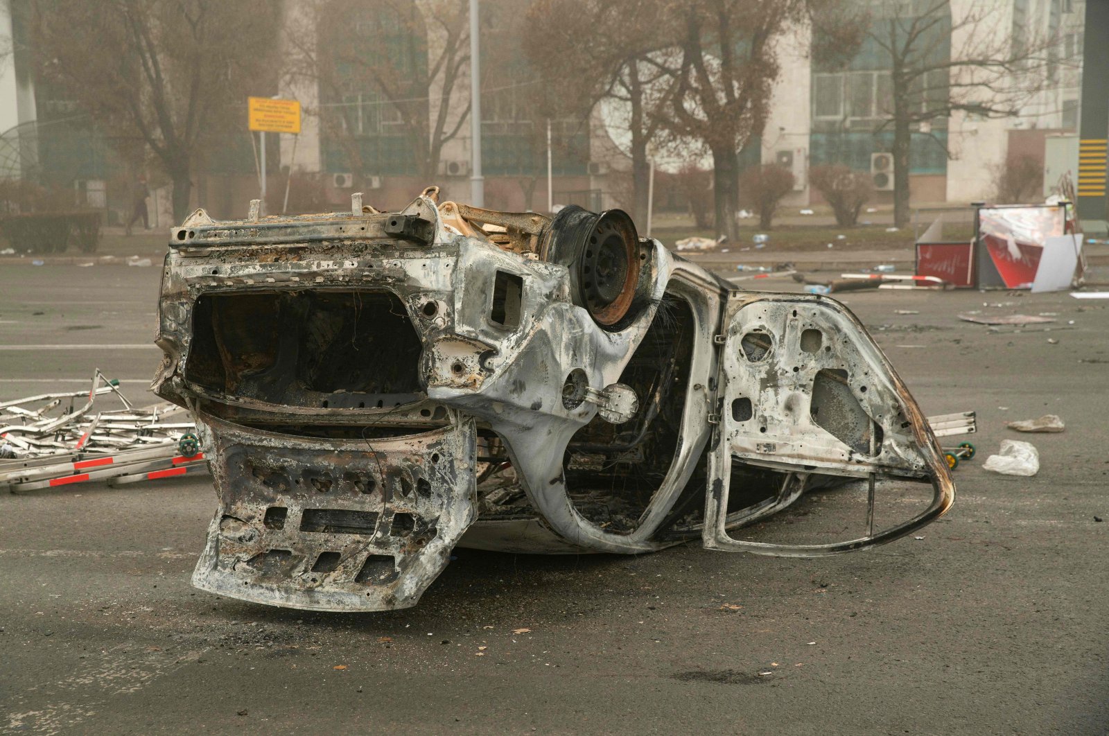 A burned-out automobile is seen on a square near an administrative quarter in central Almaty, Kazakhstan, Jan. 6, 2022. (AFP Photo)