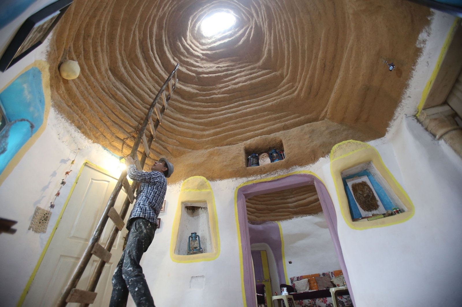 Hamed Yusuf Nazzal puts up a ladder in his house in Al-Mafraq, Jordan, Jan. 6, 2022. (AA Photo)