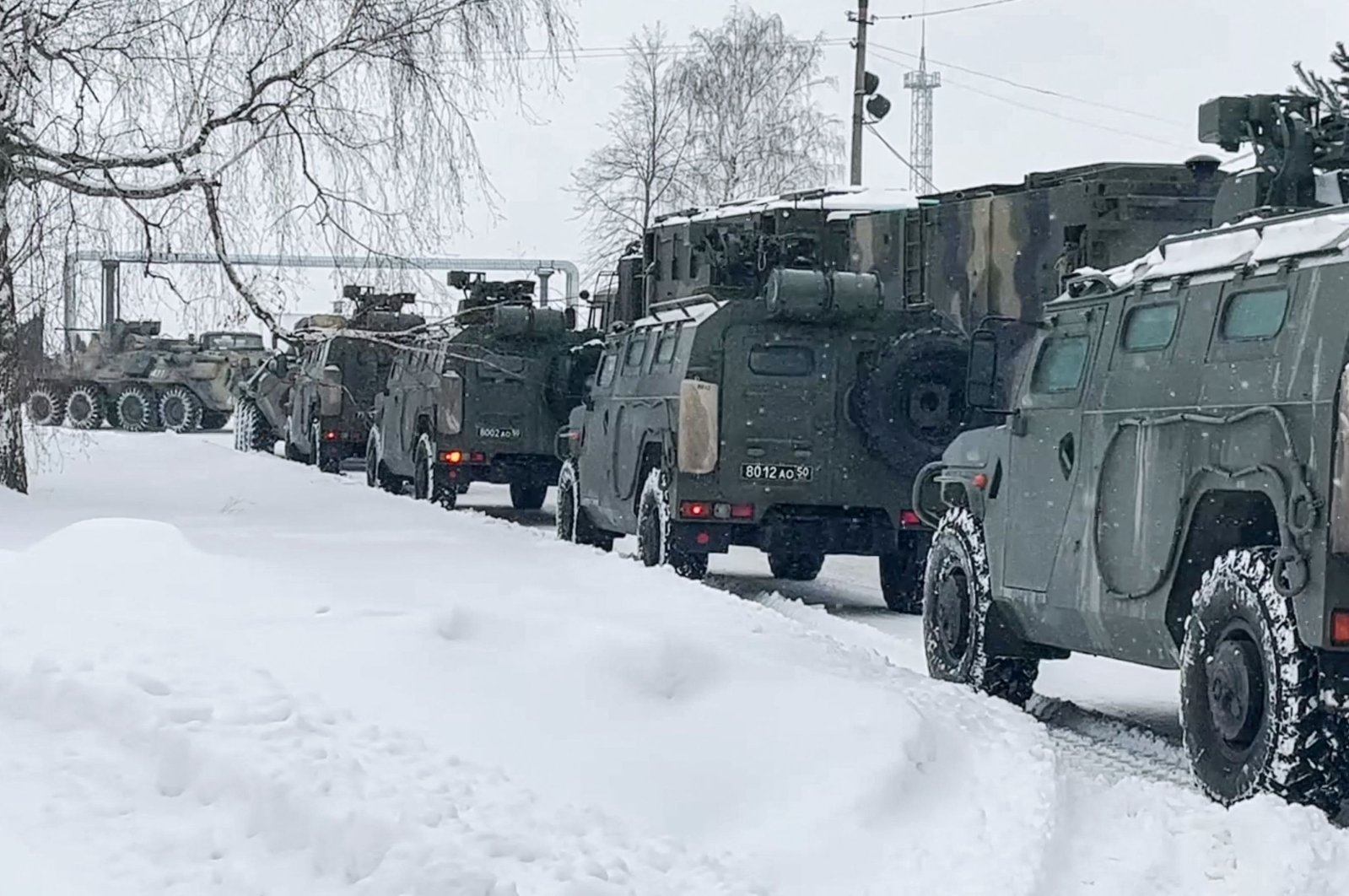This handout image grab taken and released by the Russian Defense Ministry on Jan. 6, 2021, shows Russian military vehicles waiting to load a military cargo plane to depart to Kazakhstan as a peacekeeping force at the Chkalovsky airport, outside Moscow, Russia. (AFP Photo)
