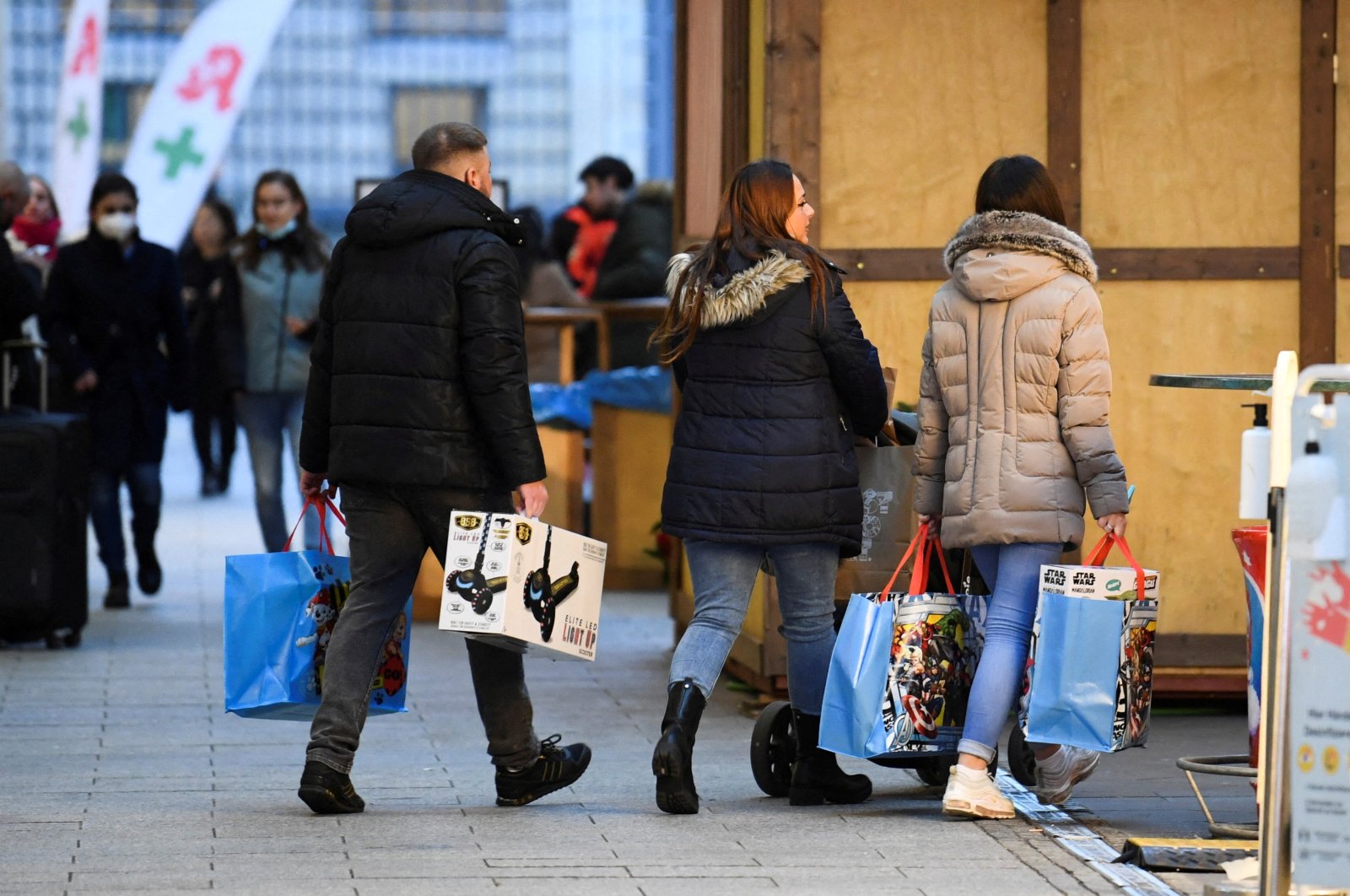 People with shopping bags walk near a shopping center in Berlin, Germany, Dec. 21, 2021. (Reuters Photo)