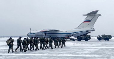 This handout image released by the Russian Defense Ministry shows Russian paratroopers boarding a military cargo plane to depart to Kazakhstan as a peacekeeping force at the Chkalovsky airport, outside Moscow, Russia, Jan. 6, 2021. (Russian Defense Ministry/ AFP)
