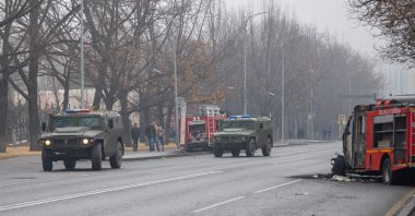 Military vehicles move along a street after violence that erupted following protests over hikes in fuel prices in central Almaty, Kazakhstan, Jan. 7, 2022. (AFP Photo)