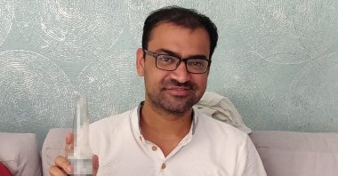 Kovid Kapoor poses for a picture while drinking a Corona beer at a relative&#039;s home in Mumbai, Jan. 7, 2022.  (Handout / AFP Photo)