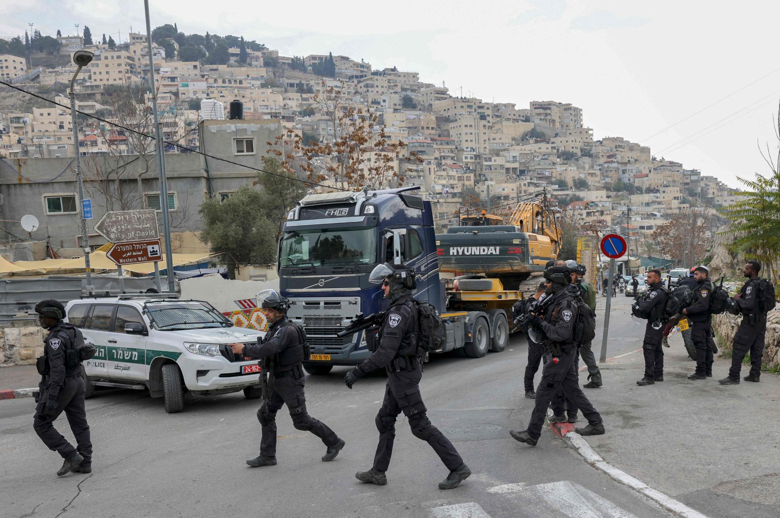 Israeli border police patrol as Jerusalem municipality workers prepare to demolish a house belonging to a Palestinian family, which Israeli authorities say was built without a permit, in the neighborhood of Silwan, East Jerusalem, occupied Palestine, on Dec. 29, 2021. (AFP Photo)