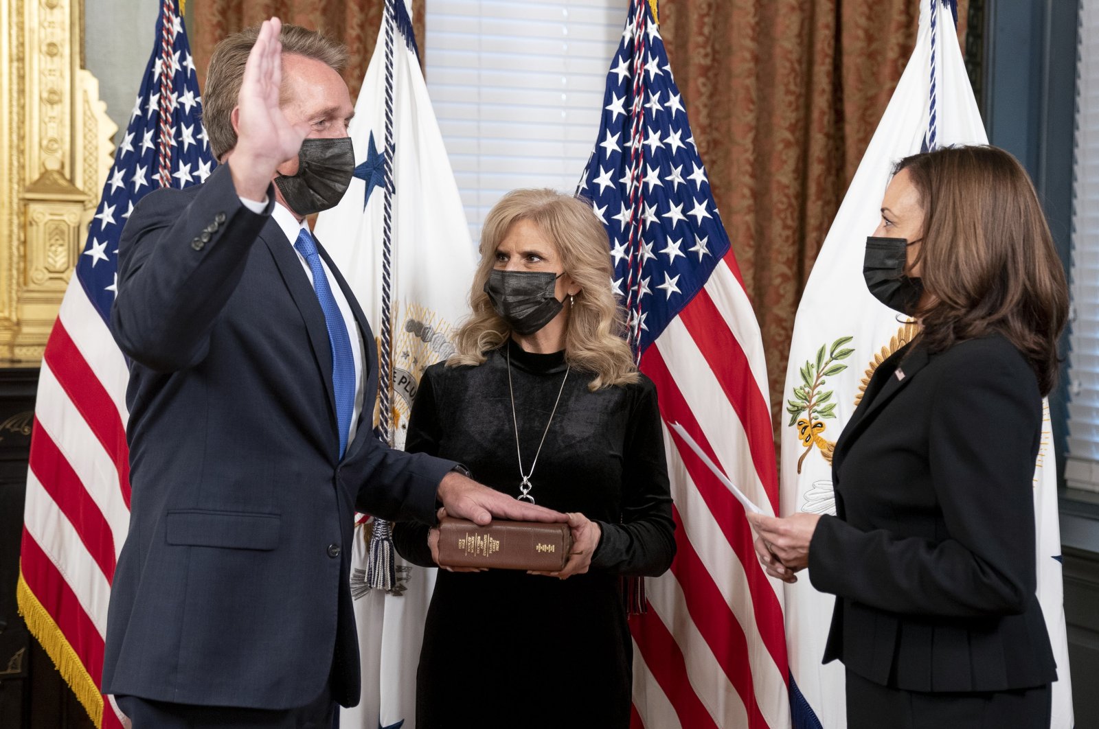 U.S. Vice President Kamala Harris (R) swears in Jeff Flake as ambassador to Turkey in the Ceremonial Office at the White House in Washington, DC, U.S., Dec. 10, 2021.  EPA/Leigh Vogel / POOL