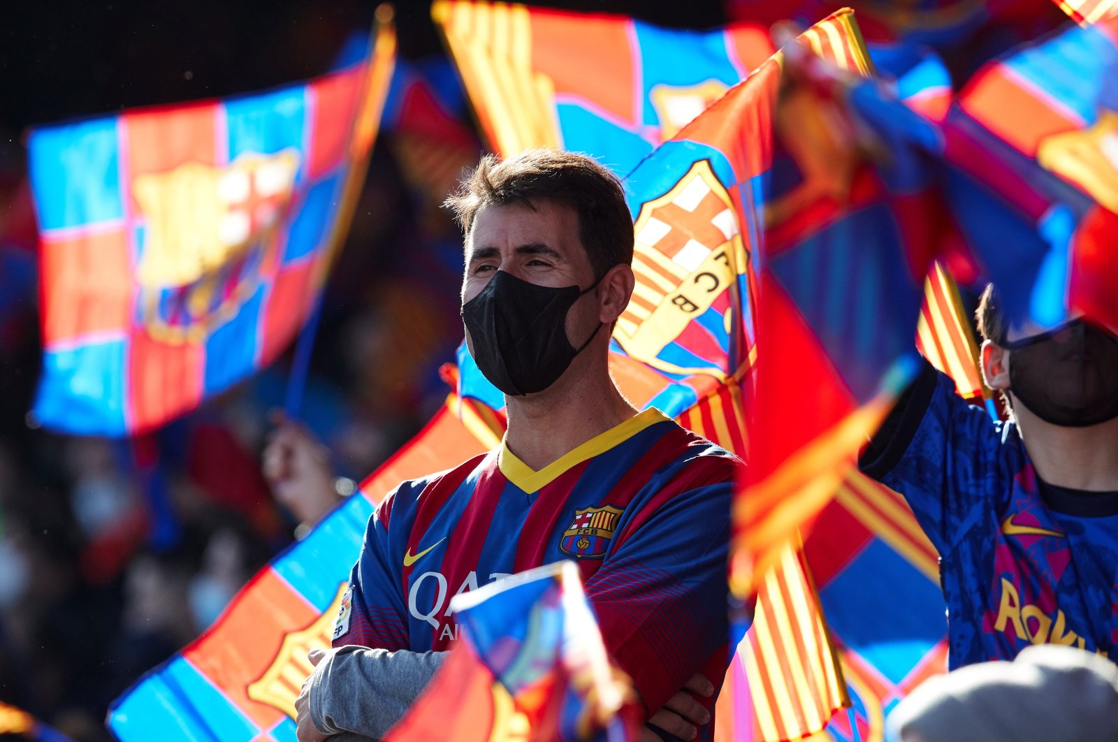 A Barcelona fan is surrounded by the club&#039;s flags during an open-door training session at the Camp Nou, Barcelona, Spain, Jan. 3, 2022. (EPA Photo)