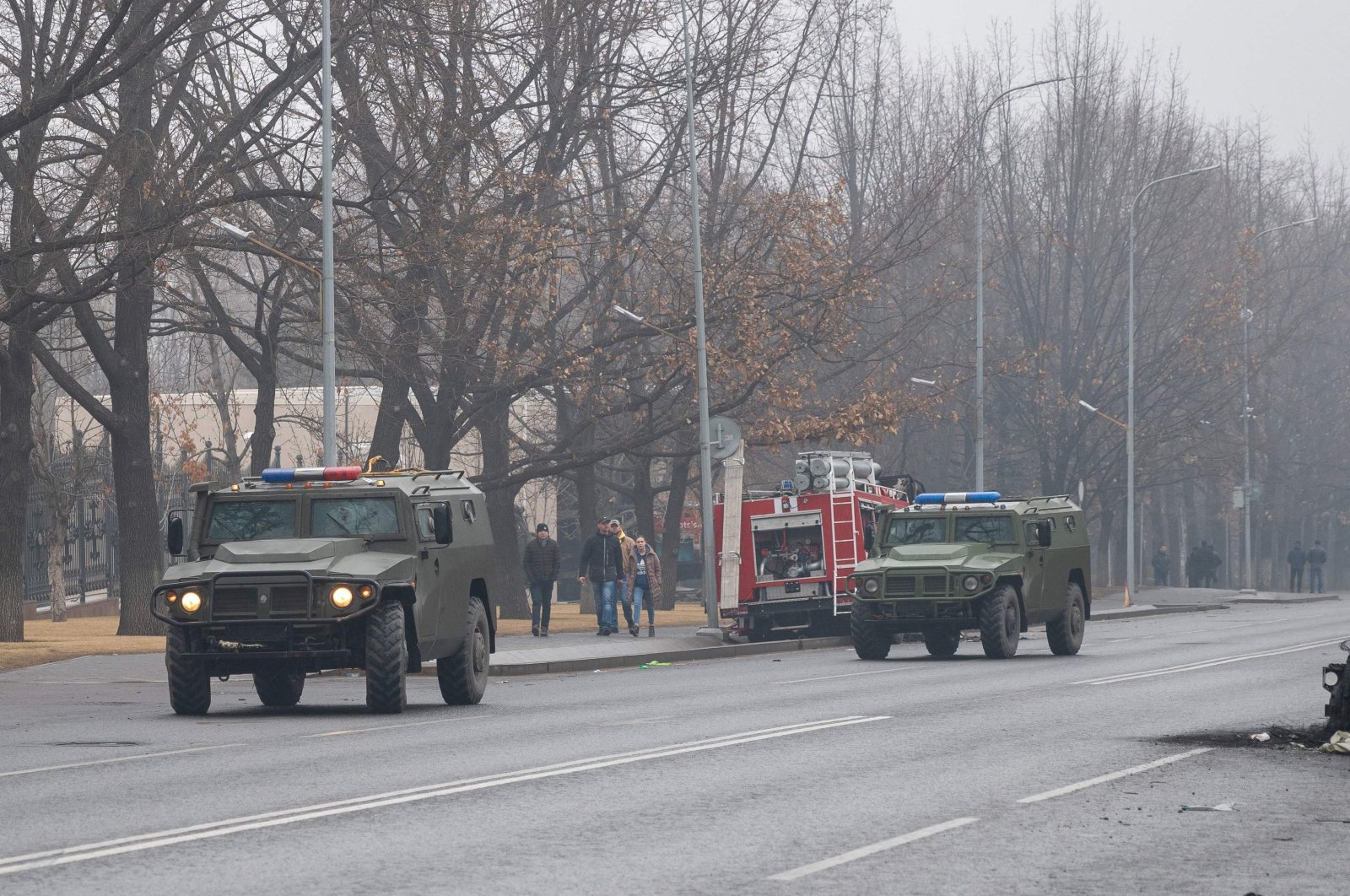 Military vehicles move along a street after violence that erupted following protests over hikes in fuel prices in central Almaty, Kazakhstan, Jan. 7, 2022. (AFP Photo)