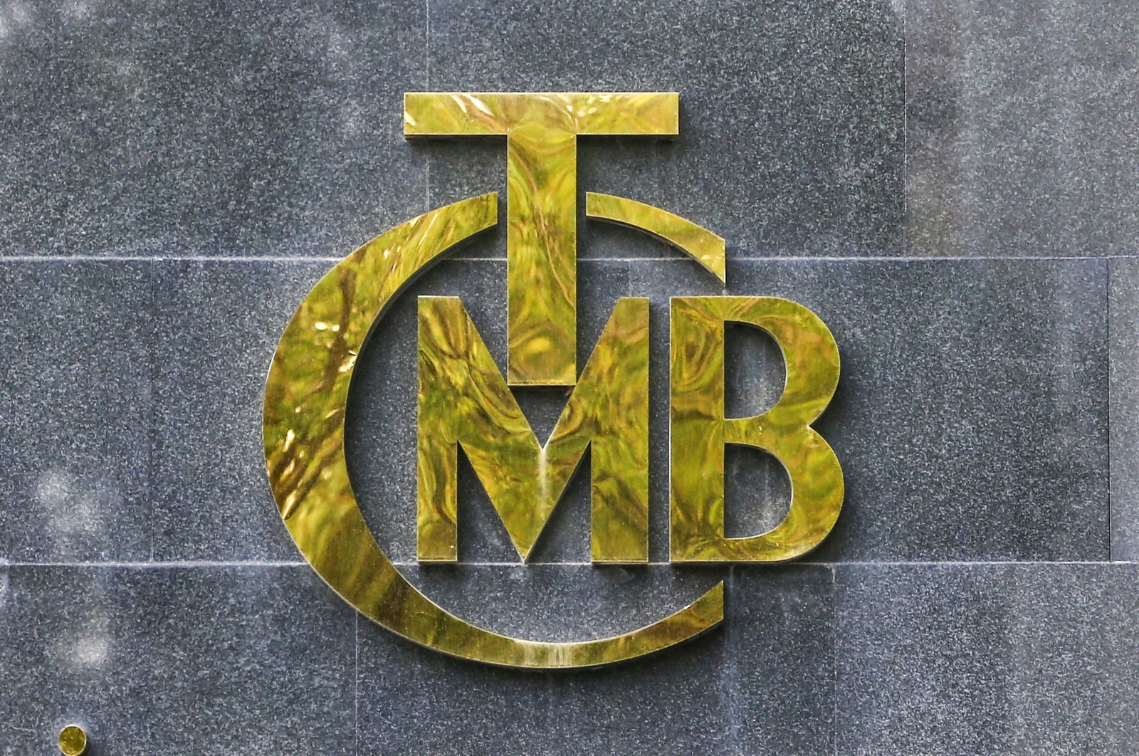 The logo of the Central Bank of the Republic of Turkey (CBRT) is pictured at the entrance of its headquarters in Ankara, Turkey, Oct. 15, 2021. (Reuters Photo)