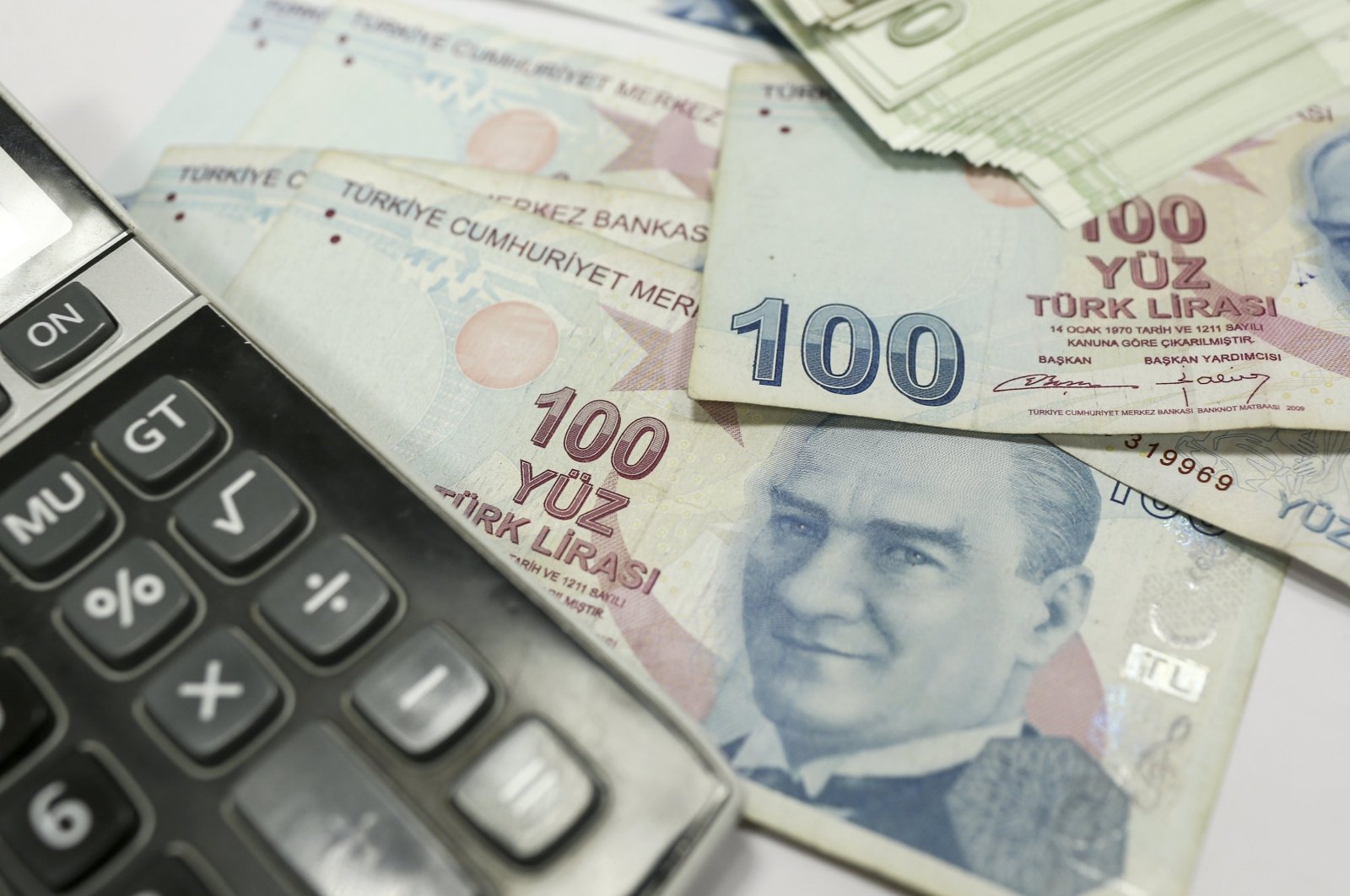 This undated file photo shows Turkish lira banknotes next to a calculator. (AA Photo)
